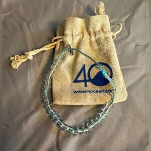 4Ocean Bracelet,  blue with clear beads, slip knot close, original bag